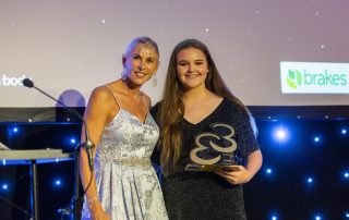 Abby Warren collecting award from Sharon Davies MBE